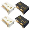 Elegant black and white gift boxes featuring gold foil moon and lantern patterns with ribbons - White Box With Gold Ribbon / White