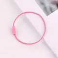 Close-up of a pink coated steel wire loop with a screw fastener for DIY keychains. - Pink
