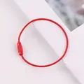 Detailed view of a red lacquer-coated steel wire loop with secure screw connector. - Red