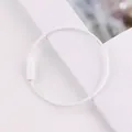 Macro detail view of a white painted steel wire keychain ring with secure screw closure mechanism - White