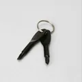 Close-up of black portable key-shaped EDC mini screwdriver set with flat and Phillips heads. - Flat And Phillips Set / Black
