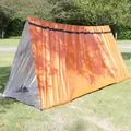 Orange PE emergency tube tent shelter set up on a green lawn for outdoor survival - Standard Type / Orange