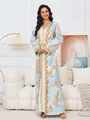 Elegant long kaftan dress with gold embroidery and blue floral patterns in a studio setting - S / Dresses / Light Blue