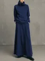 Minimalist navy blue high-neck sweatshirt and long skirt set shown on a model. - S / Top And Bottom / Blue
