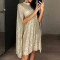 Elegant champagne gold sequin mini dress featuring a high neck and chic cape sleeves. - S / Gold