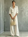 Elegant beige wide-leg linen jumpsuit with a shirt collar and belted waist for summer - White