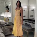 Detailed view of a yellow polka dot midi dress with tie straps and a pleated panel - S / Dresses / Yellow