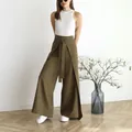 Close-up detail of olive green wide-leg trousers with a stylish tie-waist design. - XS / Bottoms / Camel