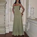 Elegant olive green strapless evening gown with waist cinching on model in ornate room - XS / Top And Bottom / Olive Green