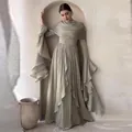 Elegant sage green pleated maxi dress with flared sleeves and matching wrap collar - Matcha Green