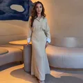Elegant beige striped two-piece set featuring long-sleeved shirt and matching maxi skirt - Apricot
