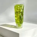 Détail d'un tube de jouet squishy avec du gel vert et des paillettes étincelantes en étoile. - Squishy Dentifrice au Maltose (T33) / Jaune