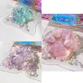 Κοντινό πλάνο με τρία γυαλιστερά παιχνίδια squishy πατούσα γάτας σε ροζ, μωβ και πράσινο - Κρυστάλλινη Πατούσα Γάτας