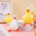 Cute duck-shaped squeeze stress relief toy in white and yellow colors - Dress-Up Duck Squishy
