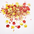 Close-up of red and gold maple leaf and star sequins for Thanksgiving party decor - Gold and Red Mix / 15g/Pack