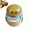 Gold glitter filled baozi squishy toy shown with its toy steamer base and packaging - Glitter Gel Expression Bun Gold With Steamer / 1 Piece