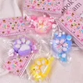 Assorted colorful cat paw squishy toys in individual packaging for stress relief - Dual Color Cat Paw