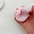 Detailed view of a soft pink pearl-textured squishy stress relief toy held in a hand - Ultra-thin Ice Crust Handmade Ball / Pink