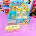 Close-up of Squeezy Butter slow rebound toy inside a transparent plastic storage case - Crispy Butter Stick (Box of 6)