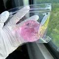 Detail shot of a translucent pink apple-shaped squishy toy in clear packaging - Apple Maltose Style / Pink