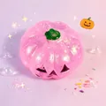 Detailed close-up view of a pink translucent glittery Halloween pumpkin squishy toy - Pink