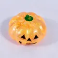 Macro detail of translucent orange Halloween pumpkin squishy toy featuring inner glitter - Yellow