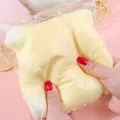Close-up showing the soft texture of a giant squishy cheese stress relief toy - Milk Yellow