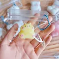Detail of cute yellow hamster squishy keychain toy in clear packaging - Yellow