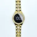 Close-up of a golden women's LED digital watch featuring sparkling rhinestones on the bezel - White / Gold