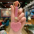 Close-up of a pink heart keychain with glittering rhinestones held by a manicured hand - 5*4.5 / Rhinestone Heart Pendant (Pink)