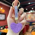 Close-up of a sparkling purple heart rhinestone keychain with a matching studded strap. - 5*4.5 / Rhinestone Heart Pendant (Purple)