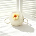 Close-up of girls' white round woven straw bag featuring a cute yellow crochet flower. - SWEET Yellow Flower / Cream