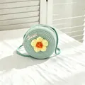 Detailed view of a girl's mint green straw woven bag featuring a yellow crochet flower - SWEET Yellow Flower / Green