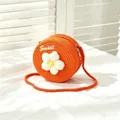 Detail view of girls' orange woven straw crossbody bag with white flower decoration - SWEET White Flower / Orange