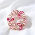 Macro view of a luxury vintage pink crystal wreath brooch set against soft white silk background - Wreath Brooch / 4CM Diameter / Pink