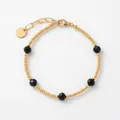 Pulsera vintage de cuentas doradas con cinco piedras negras facetadas y cadena de extensión - Estilo combinado de mostacillas negras