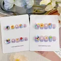 Detail view of cute pastel press-on nails with lollipop and flower designs for kids. - Children's a-c65 / Large (L)