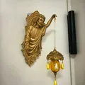 Vintage golden Jesus Christ figure wall lamp with hanging amber glass lantern detail - Poseidon Wall Lamp