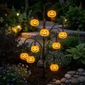 Solar-powered Halloween tree light with glowing pumpkin lanterns in an outdoor garden - Pumpkin