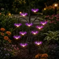 Solar Halloween stake light with purple glowing bats in a night garden setting. - Bat