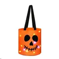 Orange Halloween candy bucket featuring LED lights and a black skull face pattern - Halloween Candy Bucket Style / Orange