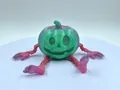 Detailansicht eines 3D-gedruckten artikulierten Kürbismonsters mit grünem Kopf und rosa Gliedern - Kürbis Smiley Gesicht / Rosa und Grün
