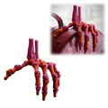 Primo piano della mano di scheletro stampata in 3D con giunti articolati e sfumatura - Mano Scheletro 3D Rossa