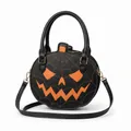Detailed view of a black Halloween pumpkin handbag with orange spider web accents. - Ghostly Orange