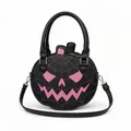 Detailed view of black Halloween pumpkin handbag with pink spiderweb Jack-o'-lantern face - Spooky Pink