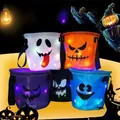 Detailed view of colorful LED glowing Halloween candy baskets with ghost faces. - Five-Piece Set