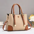 Detail einer eleganten Handtasche in Kontrastfarben mit goldfarbenen Metallteilen - 28x13x20cm / Hellbeige