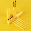 5-piece yellow makeup brush set with matching portable storage tube on yellow background. - 5 Pieces Set (Includes Storage Tube) / Yellow