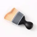 Close-up of a black curved foundation brush with wave-shaped bristles and protective cap - Style With Dust Case / 1 Piece