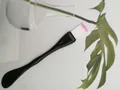 Detail of dual-use facial mask brush with soft pink-tipped bristles and flat spatula handle - Dual-End Style / Bulk Packaging / Black